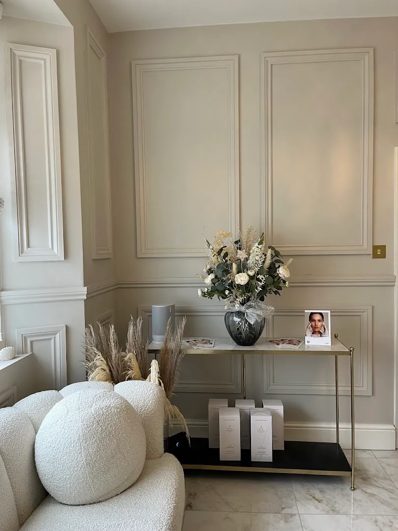 The reception of The Self-Care Clinic with fresh flowers and panelled walls